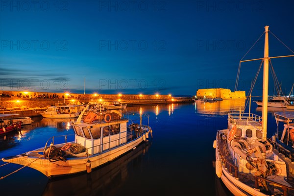 Venetian Fort Venetian fortress of Koules Castello a Mare castle in Heraklion and moored Greek fishing boats in port