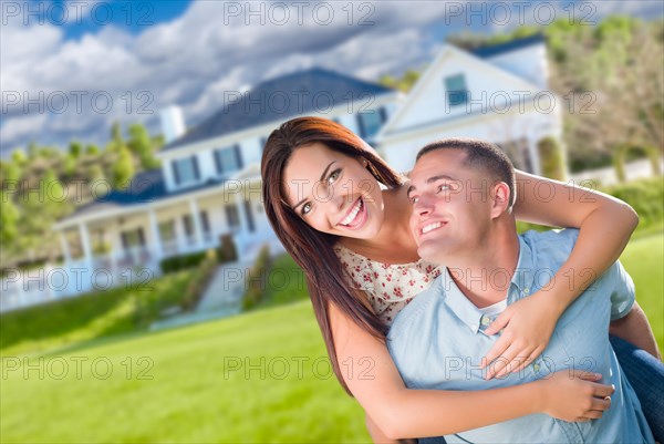 Playful young military couple outside A beautiful new home