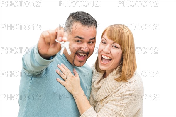 Happy mixed-race couple isolated on white holding new house keys