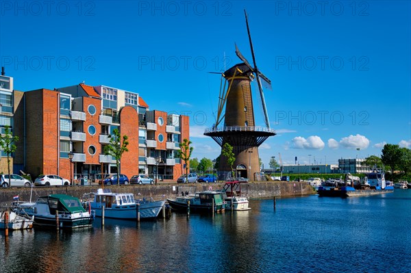 View of the harbour of Delfshaven with the old grain mill known as De Destilleerketel