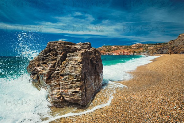 Rocks on Paleochori beach and waves of Aegean sea