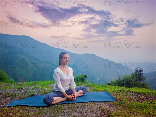 Sporty fit woman practices yoga asana Baddha Konasana