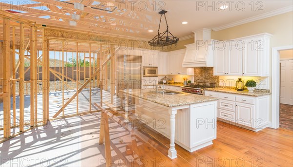 House construction framing gradating into finished kitchen build