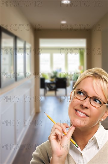 Woman with pencil inside the hallway of new house