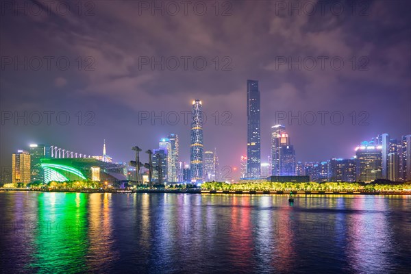 Guangzhou cityscape skyline over the Pearl River illuminated in the evening. Guangzhou