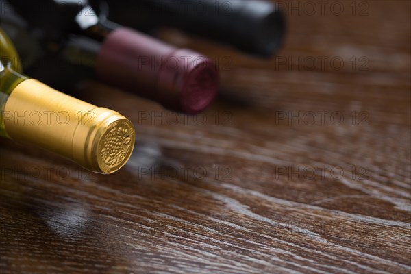 Various wine bottles on a reflective wood surface abstract