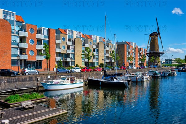 View of the harbour of Delfshaven with the old grain mill known as De Destilleerketel. Rotterdam