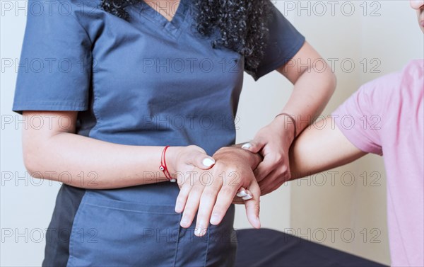 Physiotherapist with patient wrist assessment