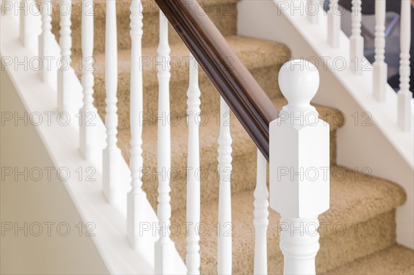 Abstract of beautiful stair railing and carpeted steps in house