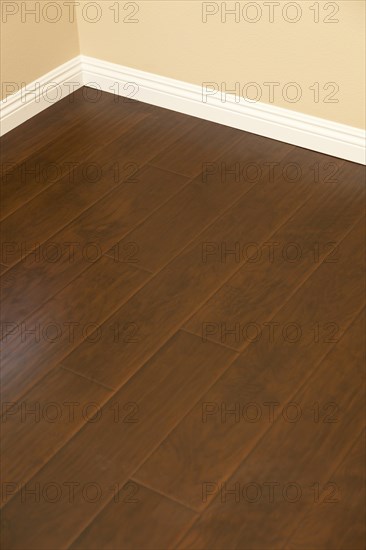 Beautiful newly installed brown laminate flooring and baseboards in home