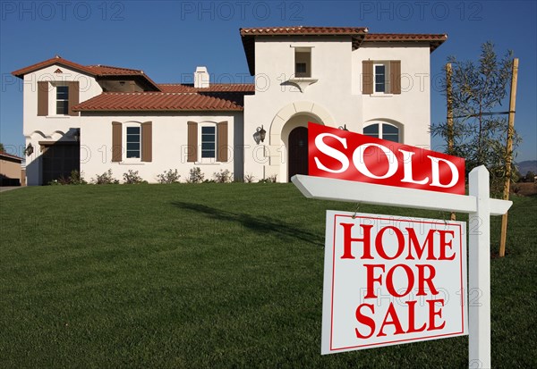 Sold home for sale sign in front of new house