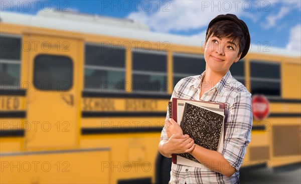 Young female student near school bus