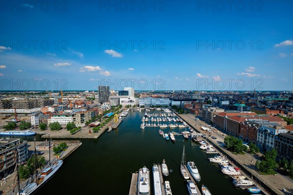 Yachts at the oldest harbor district of Antwerp city called Eilandje. Used as a yacht marina with waterfront promenade