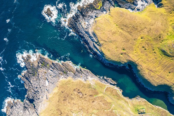 Top Down view over Geodha Smoo and Smoo Cave Cliffs from a drone