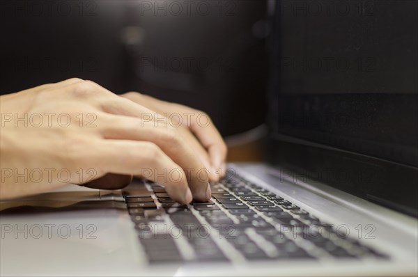 Hands on laptop keyboard