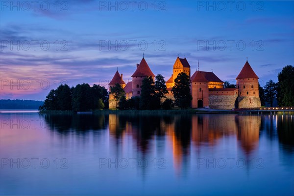 Night view of Trakai Island Castle in lake Galve illuminated in the evening