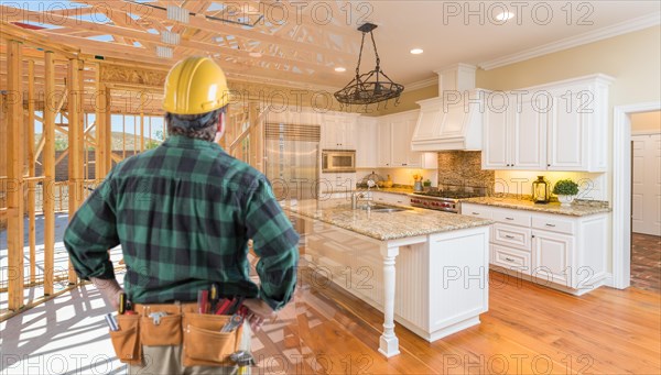 Contractor standing in front custom kitchen construction framing gradating into finished build