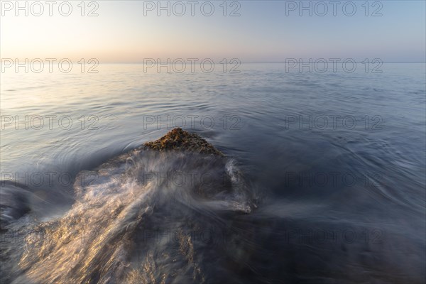 Waves lap a rock