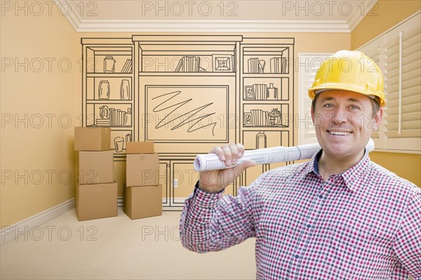 Male construction worker wearing hard hat in room with drawing of entertainment unit on wall