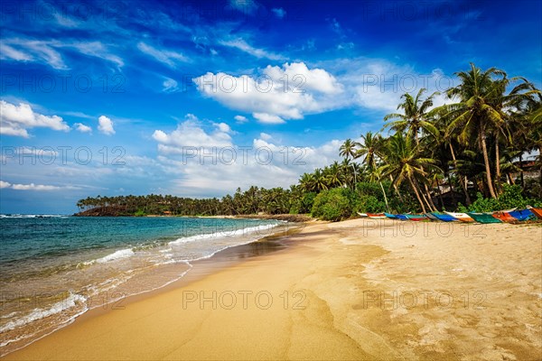 Tropical paradise idyllic beach with fishing boats on sand