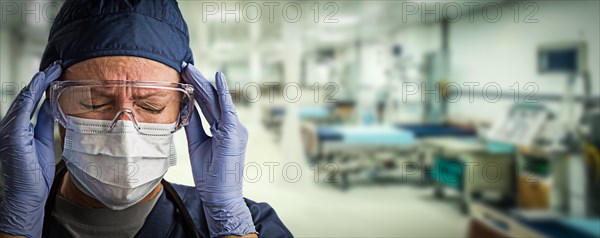 Stressed doctor or nurse wearing medical personal protective equipment