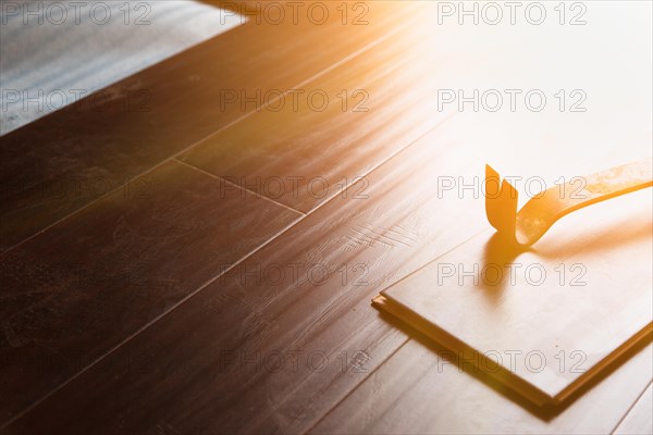 Pry bar tool with new laminate flooring abstract