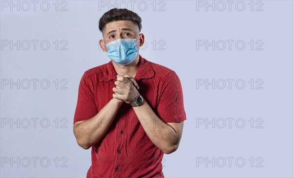 Latin man begging with medical protective face mask. pleading man concept isolated