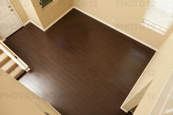 Beautiful newly installed brown laminate flooring and baseboards in home