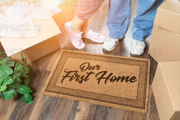 Man and woman unpacking near our first home welcome mat