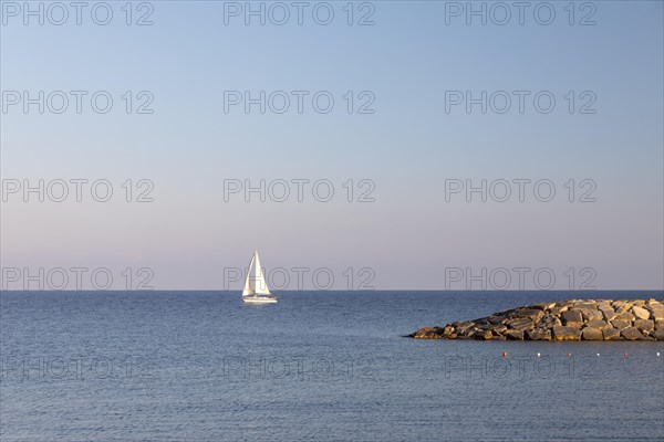 Coast with sailboat in San Lorenzo al Mare