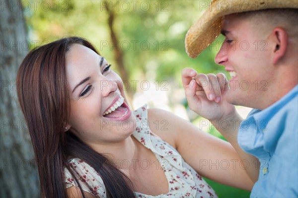 Happy romantic caucasian couple talking in the park