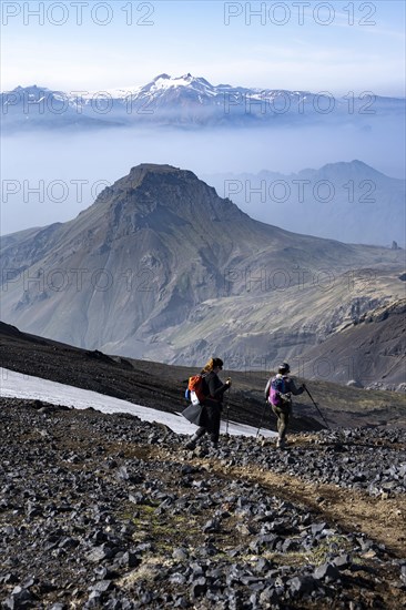 Two hikers on hiking trail through volcanic landscape