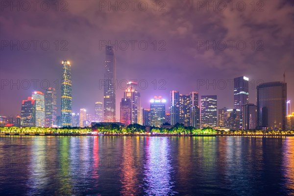 Guangzhou cityscape skyline over the Pearl River illuminated in the evening. Guangzhou