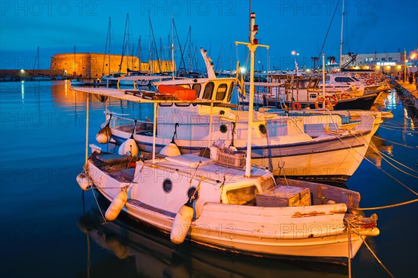 Venetian Fort Venetian fortress of Koules Castello a Mare castle in Heraklion and moored Greek fishing boats in port