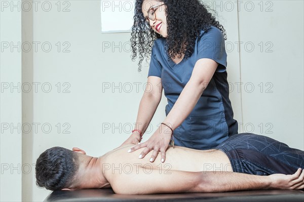 Physiotherapist curing patient's spine problems