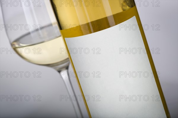 Wine glass and bottle with blank label ready for graphic and text