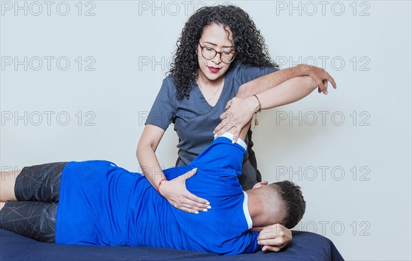 Female doctor with patient undergoing back treatment