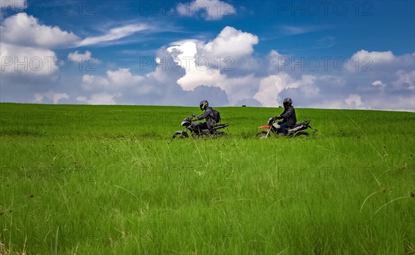 Young man on his motorcycle traveling through the countryside with copy space