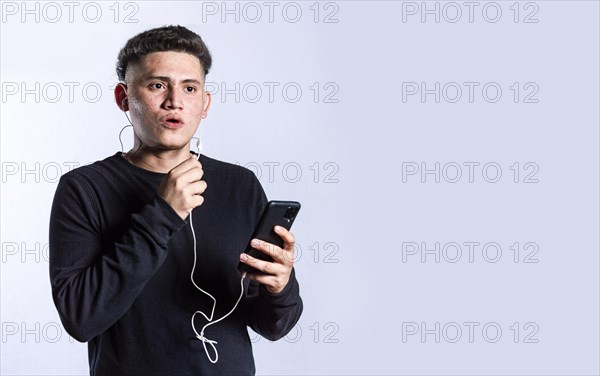Handsome man talking with headset holding cellphone