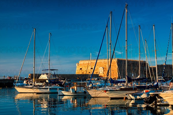 Venetian Fort Venetian fortress of Koules Castello a Mare castle in Heraklion and moored Greek fishing boats in port