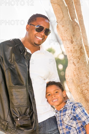 Happy african american father and mixed-race son playing at the park