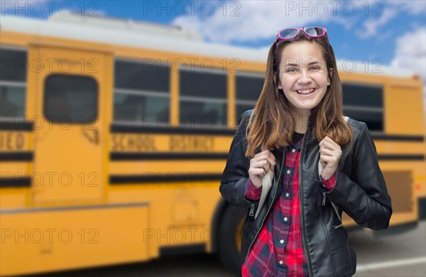 Young female student near school bus