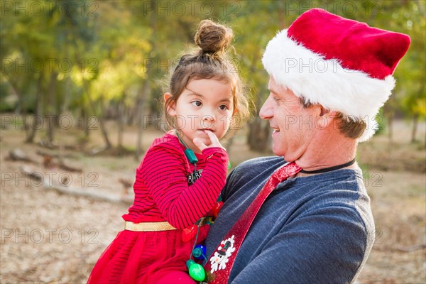 Festive grandfather and mixed-race baby girl outdoors