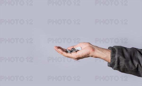 Hands with several coins in isolated background