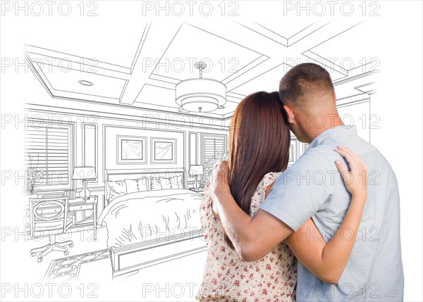 Curious young military couple looking over custom bedroom design drawing