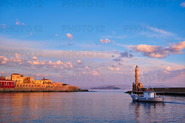 Fishing boat going to sea in picturesque old port of Chania is one of landmarks and tourist destinations of Crete island in the morning. Chania