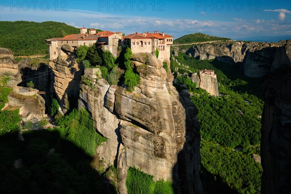 Monastery of Varlaam monastery and Monastery of Rousanou in famous greek tourist destination Meteora in Greece on sunset with scenic scenery landscape