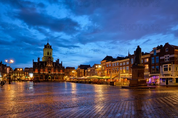 Delft City Hall and Delft Market Square Markt with Hugo de Groot Monument in the evening