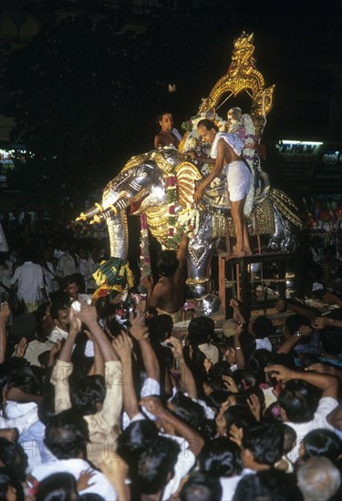 Lord Sundareswarar and Goddess priyavidai mounted on silver elephant vahanam going in a procession in Madurai