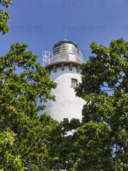 White lighthouse Langer Erik between trees